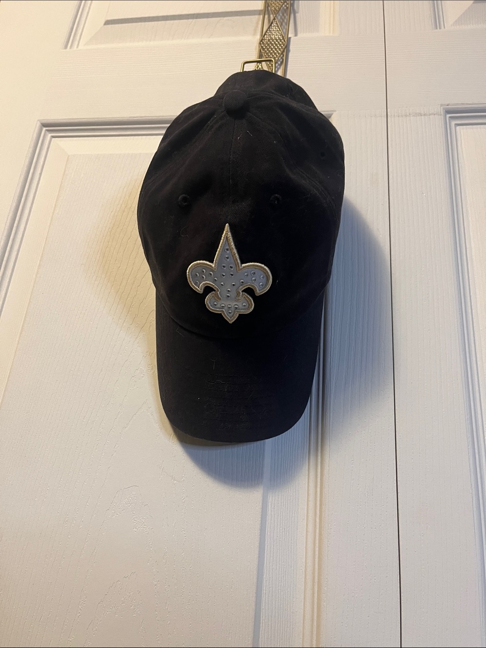 Black Baseball Cap with Decorative Fleur-de-Lis Patch